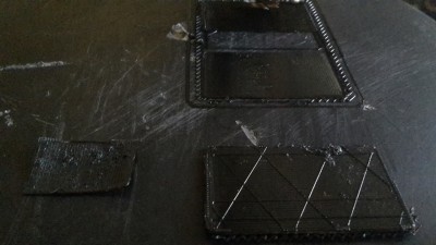 Here are three generations of ABS prints, slowly making progress, but I am still getting small globs and rough ridges, and having adhesion problems as well toward the center. Dropping Z height to see if that has any effect..