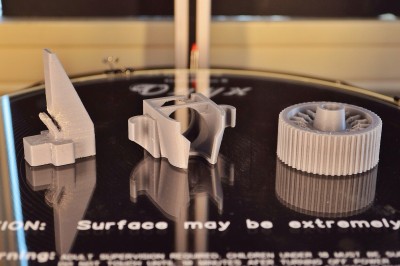 Three of the four items I printed on my first day running. The other PEEK fan was installed to print these three.