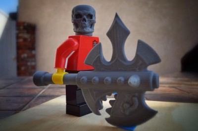 Skull and Axe printed for large format Lego figure. He custom makes these for little minifigs with injection molding, these were printed for displays at the various Lego conventions he goes to.
