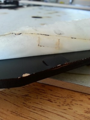 Incomplete hole and cracked edge.