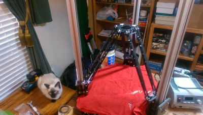 Arms connected and inverted to install hot end. (Note, I was able to get a shot of the invisible cat that assists with the build)